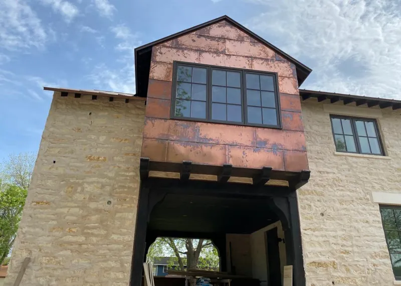 Copper metal panel facade on a stone building for Skylight Installation in East Pasadena
